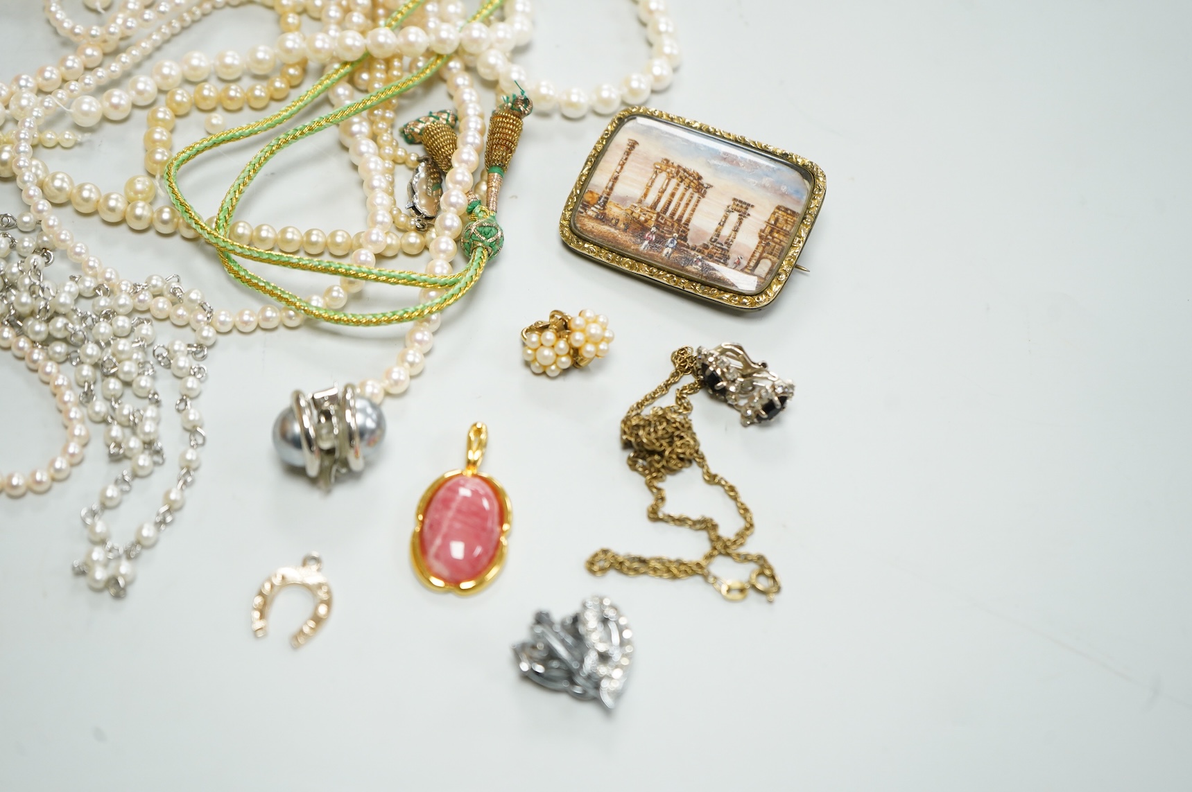 A collection of assorted jewellery including a jade bangle, cultured pearl necklaces and a diamond set yellow metal and quartz ring.